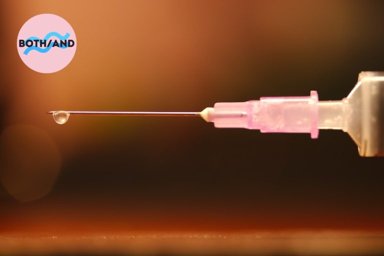 A syringe beading with a drop of liquid
